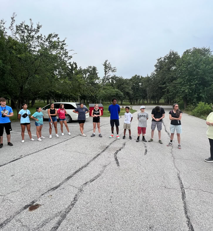Members from the missions team leading a prayer circle before taking a hike in the Wichita Mountains with the local youth.